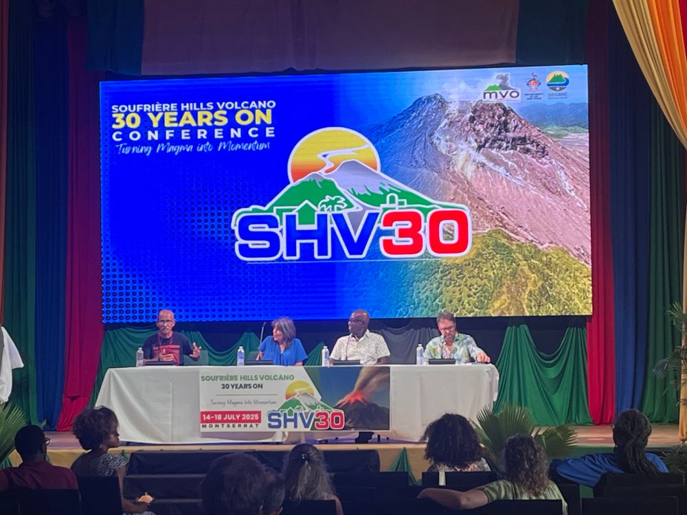 Photograph of a discussion panel, sitting in front of the SHV30 banner. Left to right, Prof Richie Robertson (UWI SRC), Prof Jenni Barclay (University of Bristol), the Honorable Dr Keith Rowley (former prime minister, Trinidad and Tobago) and Dr JC Komorowski (head of observatories, IPGP).