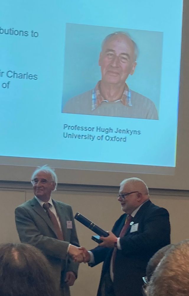 Photograph of Hugh Jenkyns (University of Oxford; left) receiving the Lyell Medal from Geological Society President, Jon Gluyas.