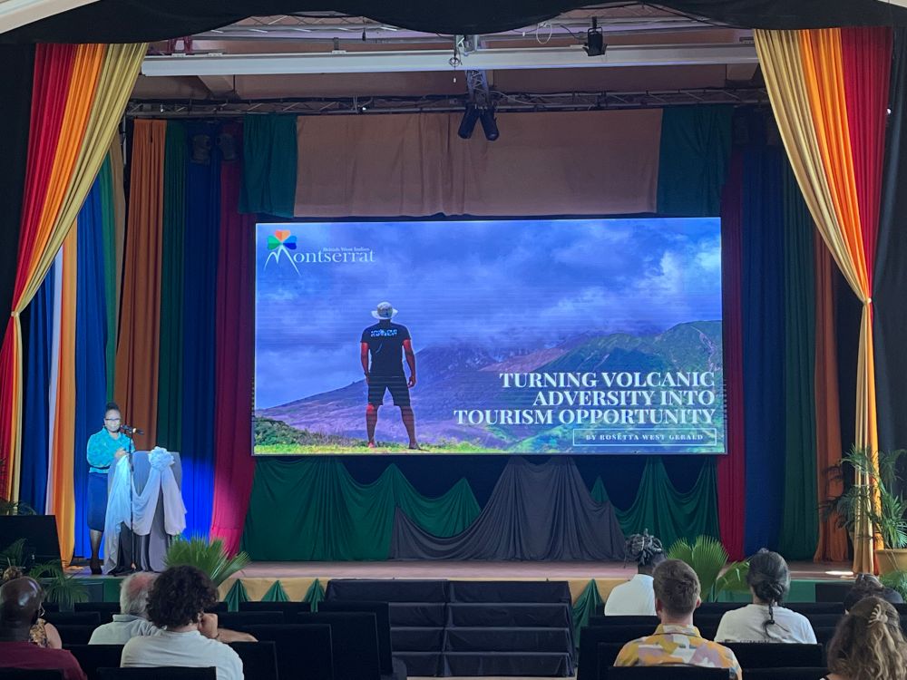 Photograph of Rosetta West Gerald at a podium presenting on tourism opportunities on Montserrat.