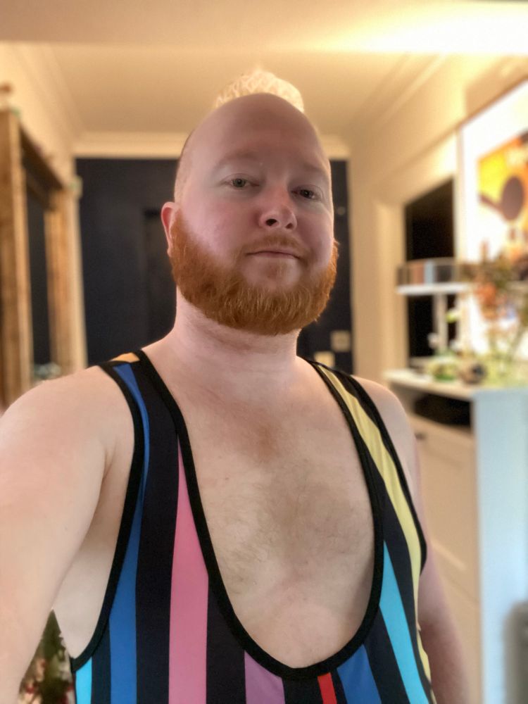 Stannum shows off his rainbow-tone wrestling singlet. Part clown, part strongman, all beard and all belly 😁
