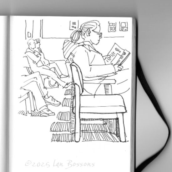 An open sketchbook showing a black and white line drawing of several people sitting waiting. The young woman in the foreground is sitting next to an empty chair and is reading a paper.