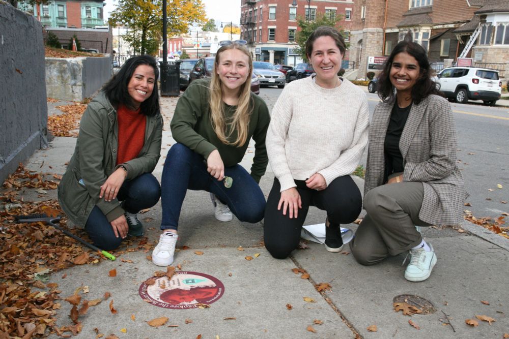 Above: Marisa Meldonian, Samantha Pardo, Eliza Novick, and Divya Varghese at one of the Women's History Trail markers on Washington Street opposite Mother's Rest Park in Four Corners. Seth Daniel photo. 