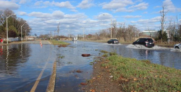 A photo of a flooded-out Morrissey Blvd shows cars splashing through the roadway.