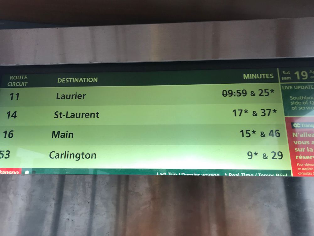 A bus timetable board that displays departure times. The #11 bus, one of the busiest routes, cancels its 9:59 departure and the next one is scheduled to leave 25 minutes later.
