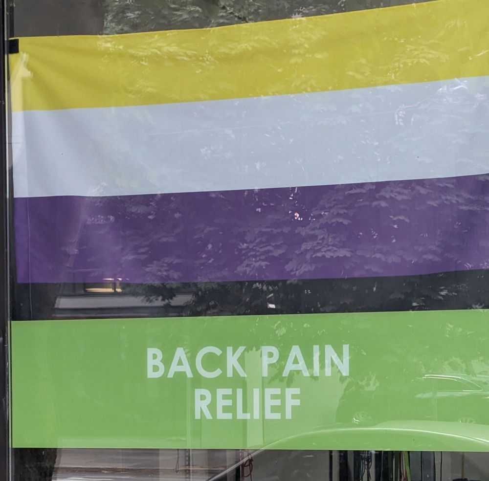Nonbinary flag with the words "BACK PAIN RELIEF" 
