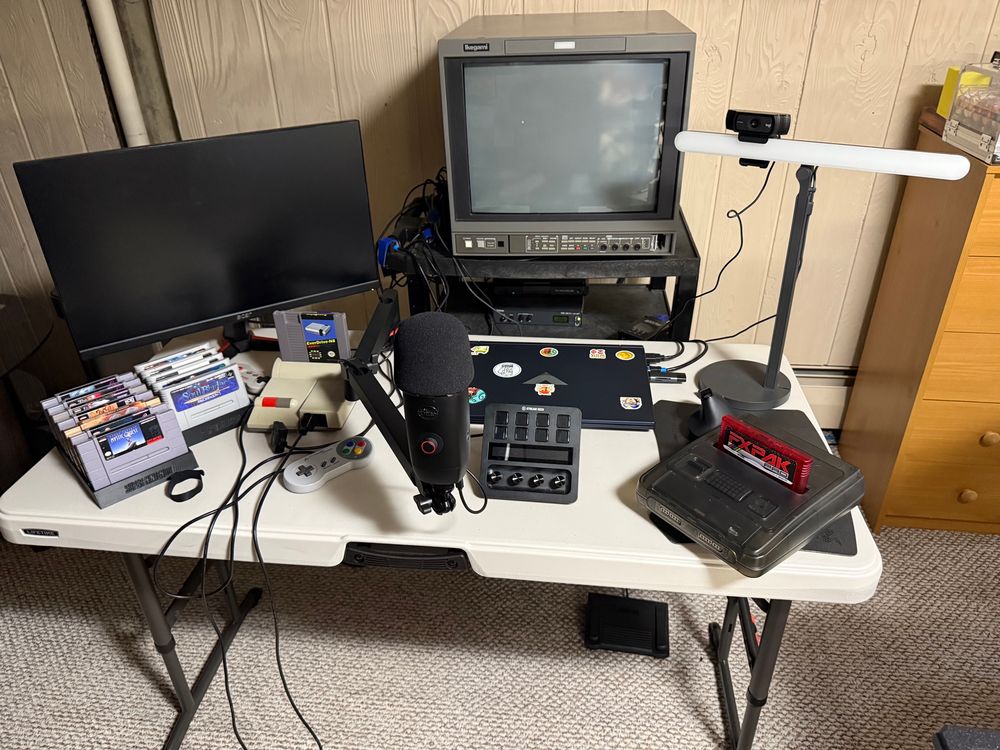 SNES/SFC games in 3d printed racks, old flat panel monitor for computer, modded systems, laptop, Stream Deck#, Yeti X mike, Logitech 1080p cam, light thingy, Retrotink 4k, Retron 203 Rxi, Ikegami HTM-1907R, amd MiSTer.