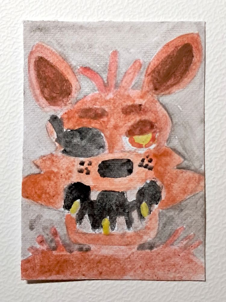Une carte représentant la tête de Foxy, un animatronique renard roux avec un cache-œil, la gueule ouverte montrant des dents terrifiantes, sur fond gris.