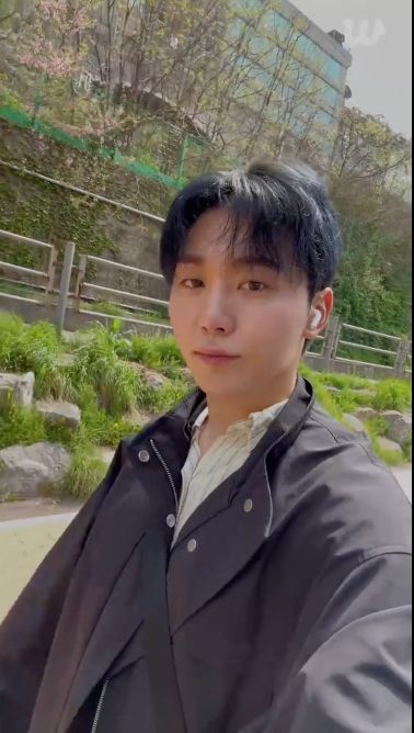 seungkwan walking on a sidewalk