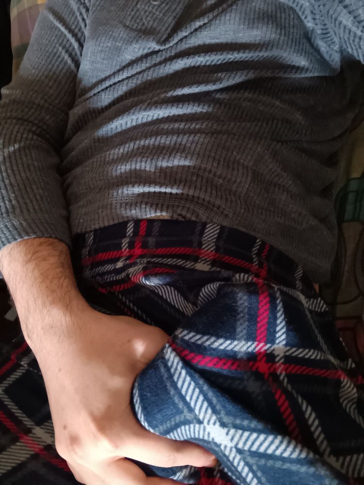 Me holding my erection that is concealed by pajama pants
