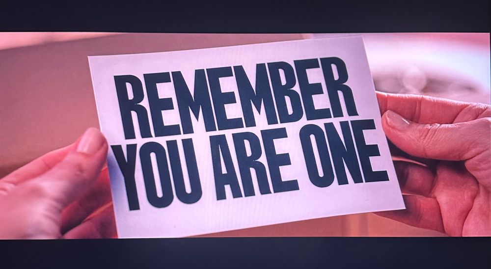 Scene from The Substance (2025) where Elisabeth goes through the instructions for the substance and the last panel reads “REMEMBER YOU ARE ONE”