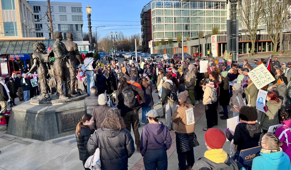 MLK gathering at a statue 