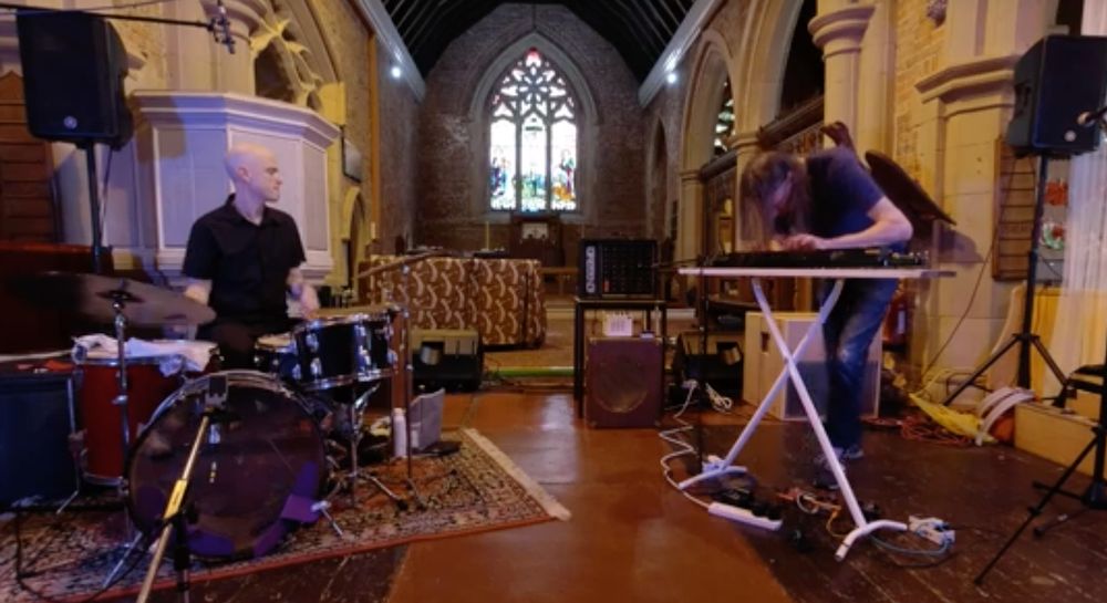 in a church, Chris Corsano plays drums, Mick Flower plays shahi baaja