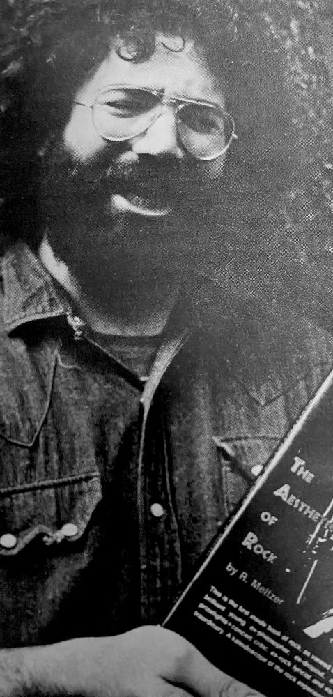Jerry Garcia holds a copy of "the Aesthetics of Rock" by R. Meltzer, from Circus Magazine, 9/70