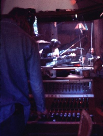 Stephen Barncard at console in control room. Jerry Garcia and Keith Godchaux visible through glass
