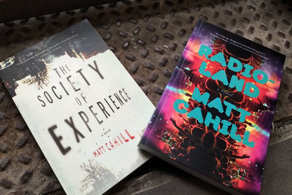 My two novels laying on nicely art-directed industrial flooring.