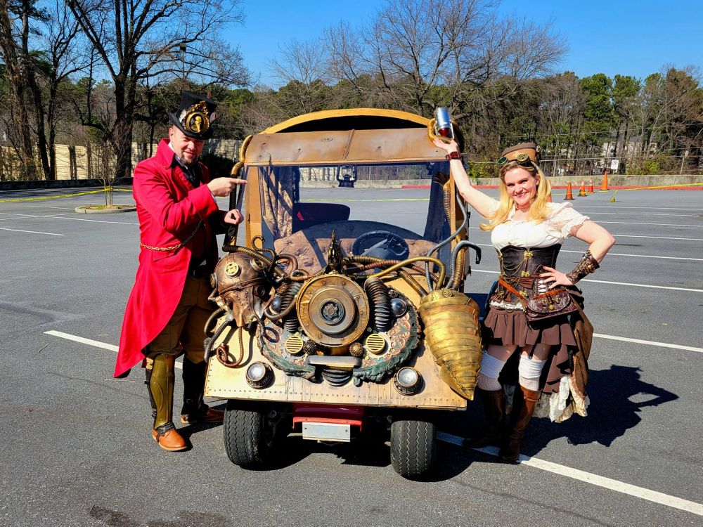 Dave Lee & Sherri Lehmbeck pose with the "Submersible Ambulance," an original creation of Sherri Lehmbeck's, during our 2022 "Death Races" at "Steampunk Atlantis!"