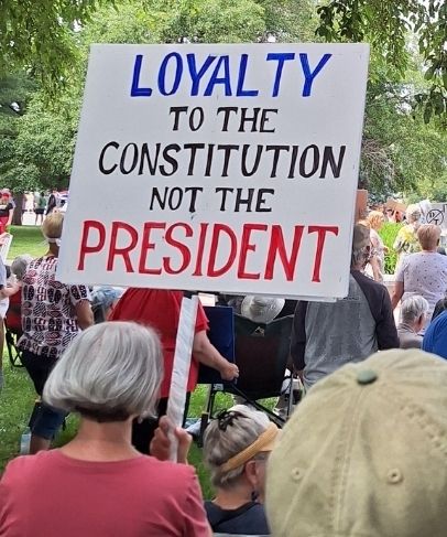 The sign reads "Loyalty to the Constitution not the president."