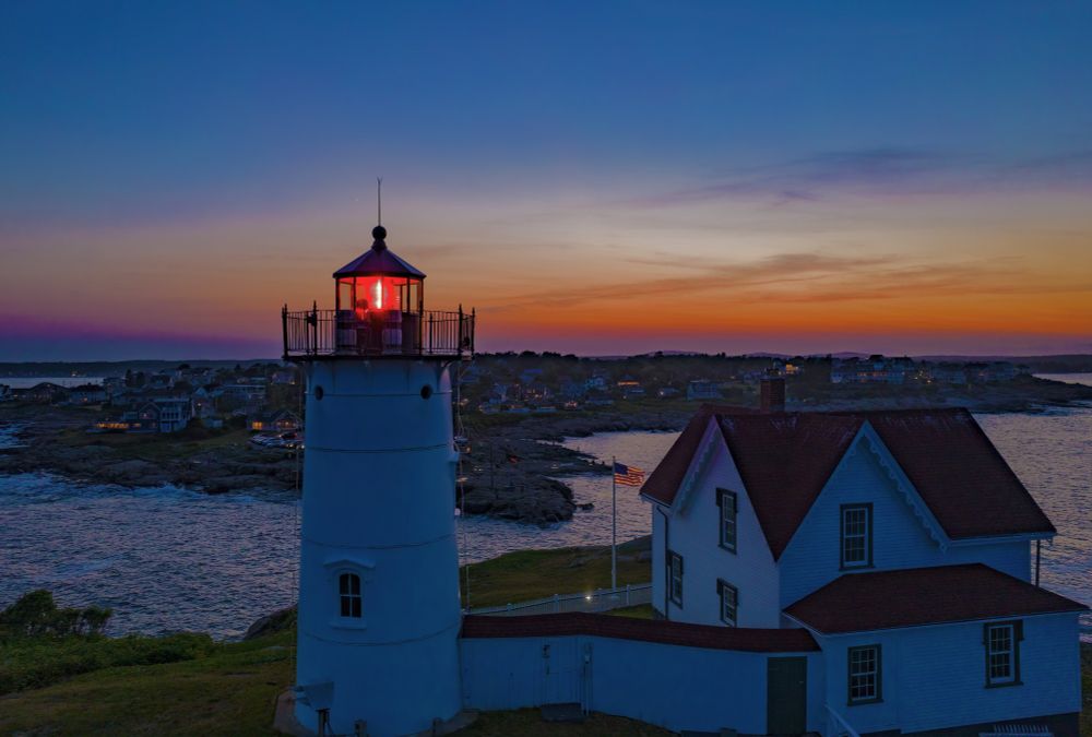 A Twilight aerial view of the Nubble Light house showcasing Cape Neddick in York Me