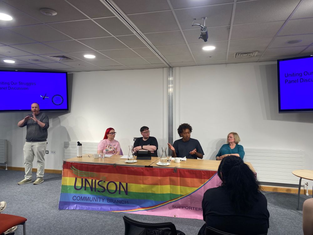 Four panelists at a table.