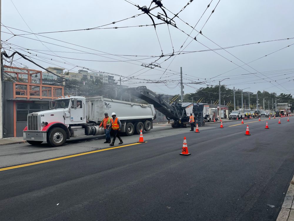 Construction crews grinding and hauling away asphalt on Presidio Avenue.