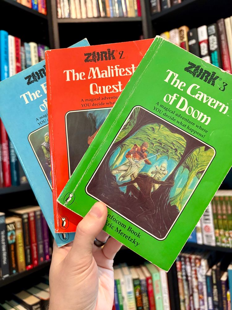 Three Zork  choose-your-own-adventure style books. 