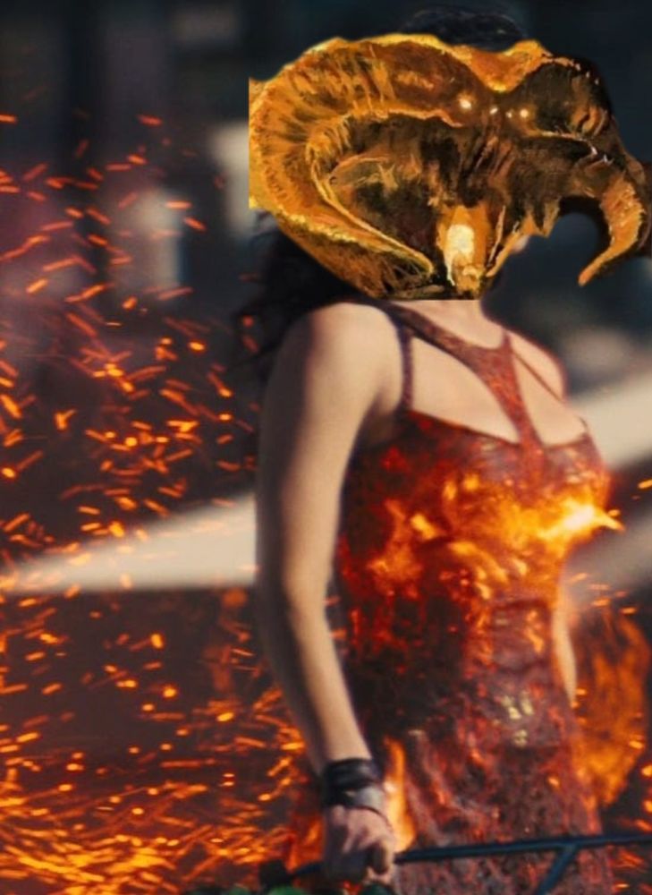 Ein Bild von Jennifer Lawrence als Katniss Everdeen in einem flammenden Kleid aus den Hunger Games-Filmen. Über ihren Kopf wurde mittels Bildbearbeitung ein Balrogkopf gelegt