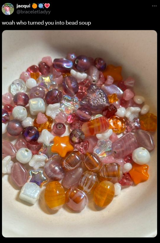 A tweet by @braceletladyy with a picture of a bowl filled with beads of various shapes including spheres, stars, oblong rectangles, and more. The beads resemble a sugary breakfast cereal.