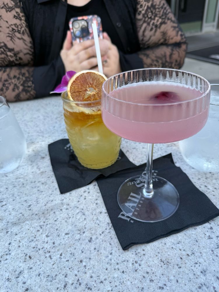 A mai Thai and a pink gin drink with a flower in it
