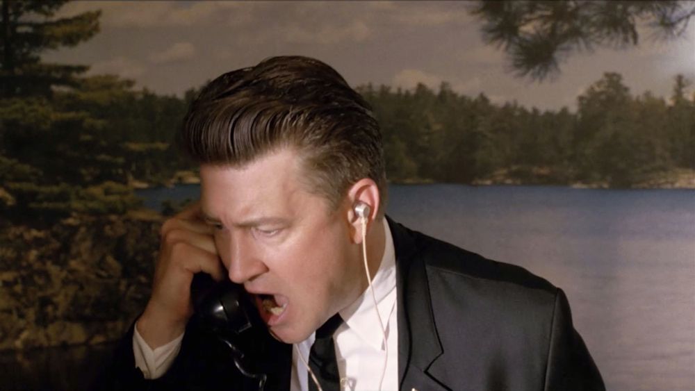 A still from the movie "Twin Peaks: Fire Walk With Me" showing David Lynch in the role of Gordon Cole, yelling into a phone
