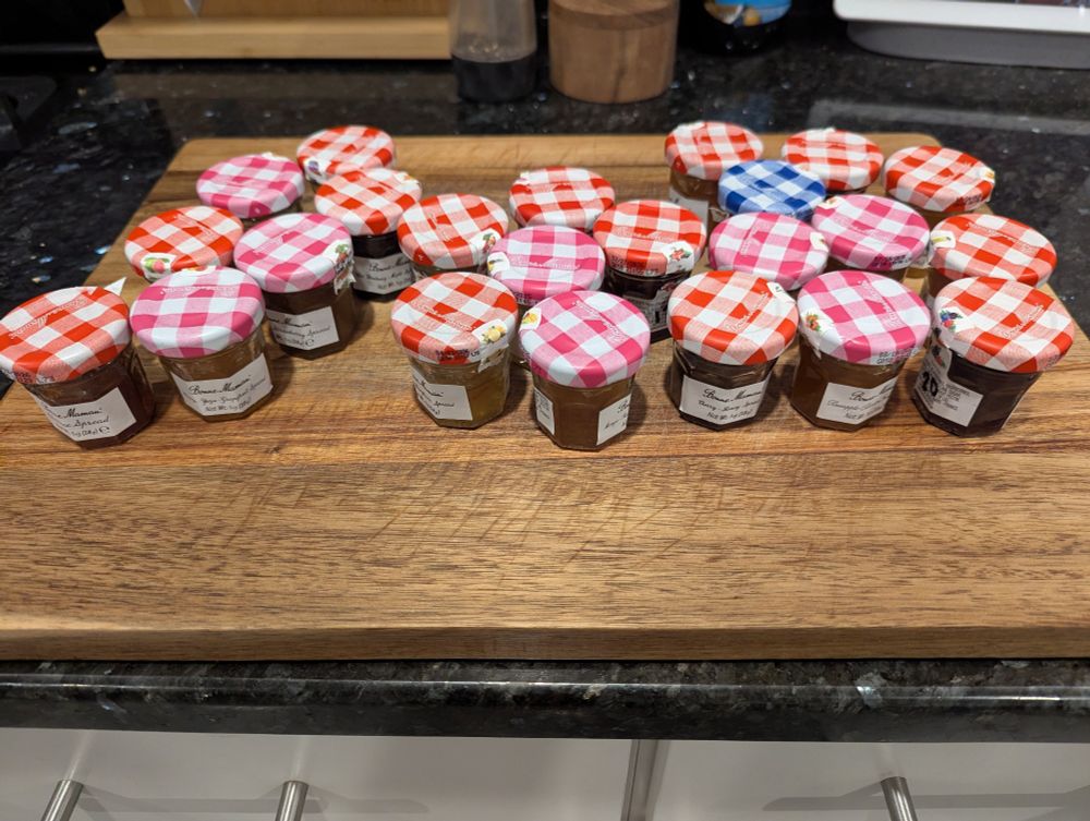 a collection of tiny jam/jelly/spread jars