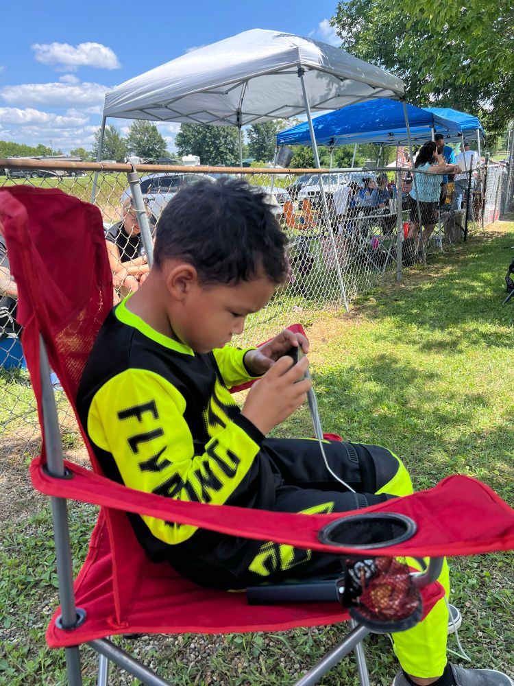 BMX racer playing Roblox between races