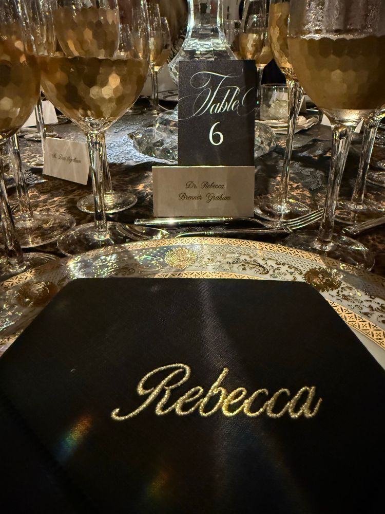 napkin that says Rebecca and a fancy place setting