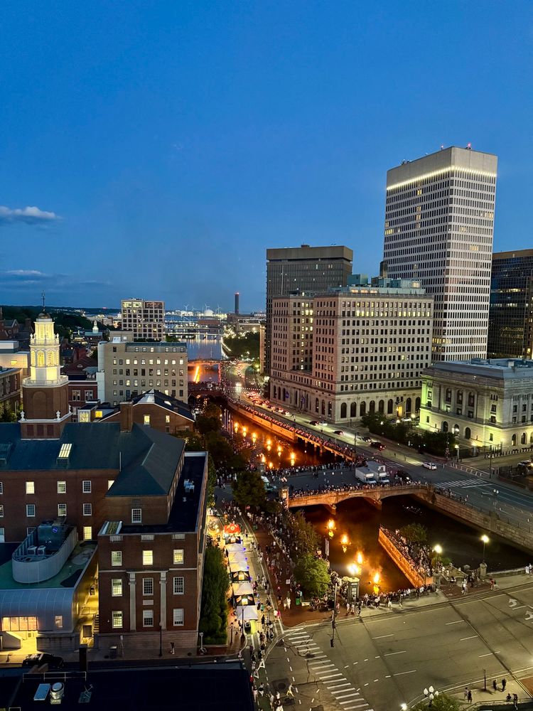 rooftop view of fire on the river beneath the Providence skyline 