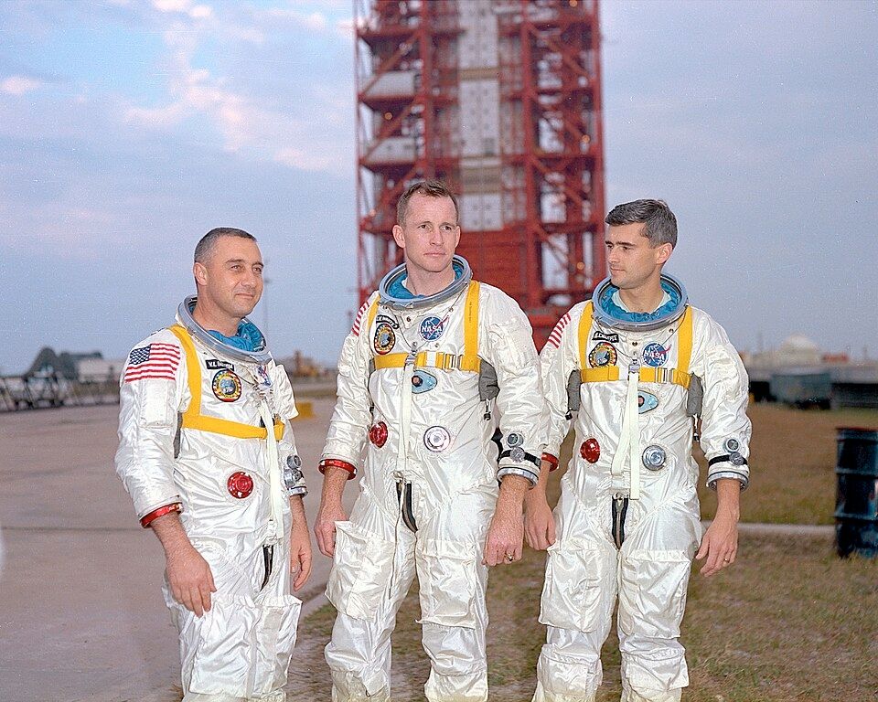 Gus Grissom, Ed White, and Roger B. Chaffee
in front of the launch pad containing
their AS-204 space vehicle. 