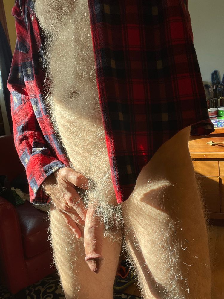 Just some naked hairy guy wearing a flannel shirt.