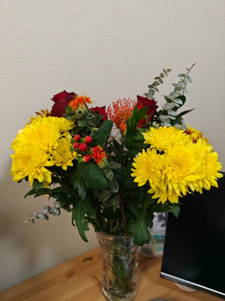 Bouquet of flowers I bought for myself. An assortment of yellow red and orange flowers (I apologize I don't know the names of each one except the roses)