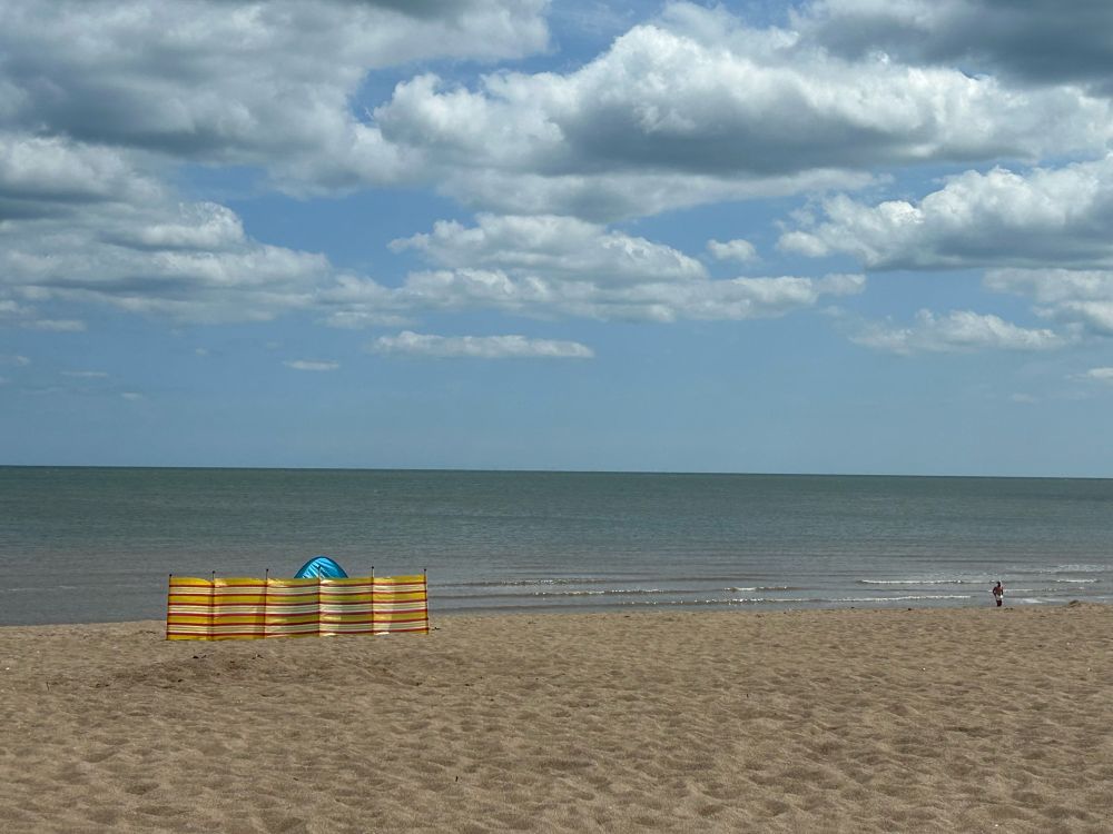 A yellow windbreak on a beach 