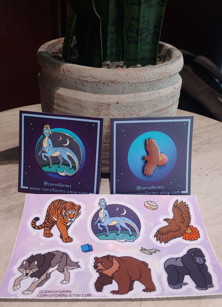 Animorphs merch featuring a sticker sheet with Ax, Tobias (redtailed hawk), Jake (tiger), Cassie (wolf), Marco (gorilla) and Rachel (bear). Plus Ax and Tobias pins.