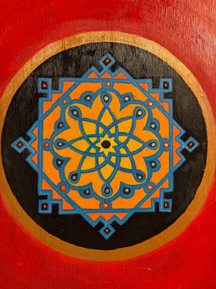 Mandala-like design from the Alhambra on a red background.