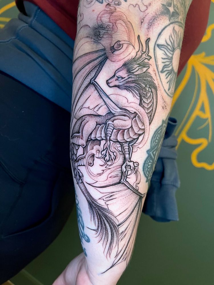 Black illustrated dragon tattoo 