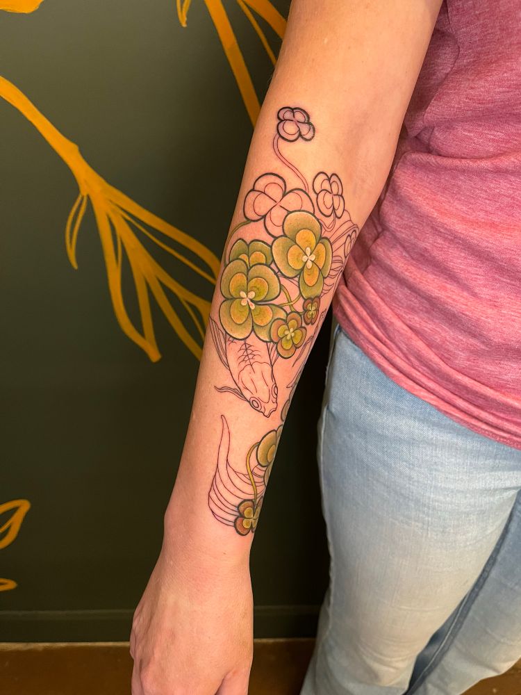 Koi fish under some water clovers tattoo 