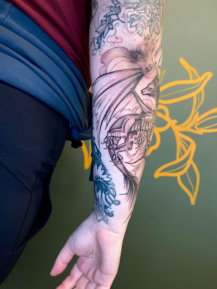 Black illustrated dragon tattoo 