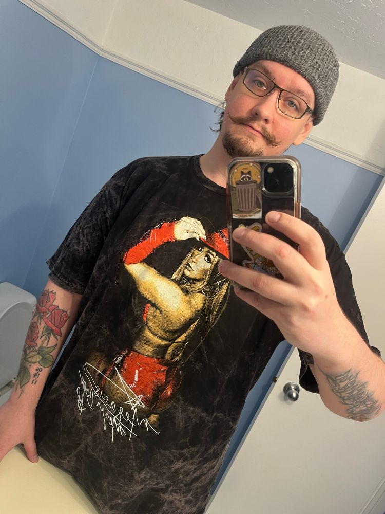 Selfie of Mike in a mirror with a grey beanie and a Megan Bayne shirt