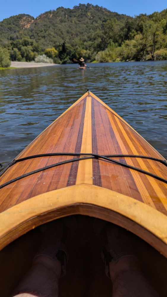 Bow of my wooden kayak looking upriver on the Russian River, California 