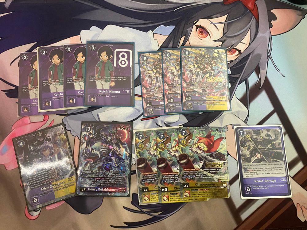 A bunch of purple and yellow digimon trading cards 
