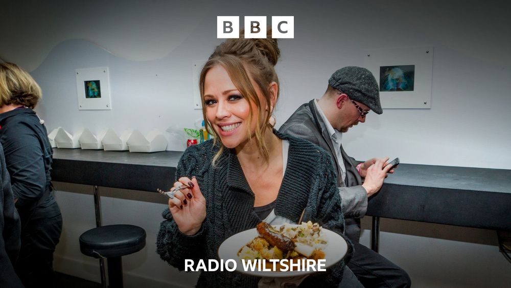 Kimberly Walsh happily holding a plate of food in a promo photo for BBC Radio Wiltshire.