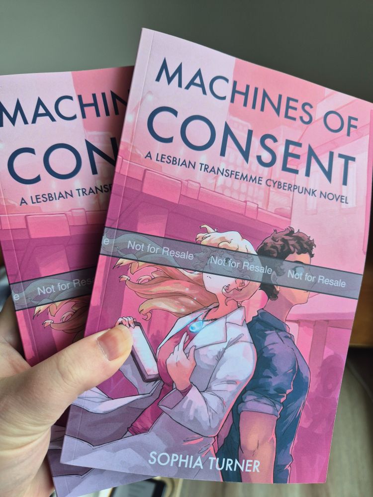 Me holding two proof copies of my first novel: machines of consent. They look gorgeous!