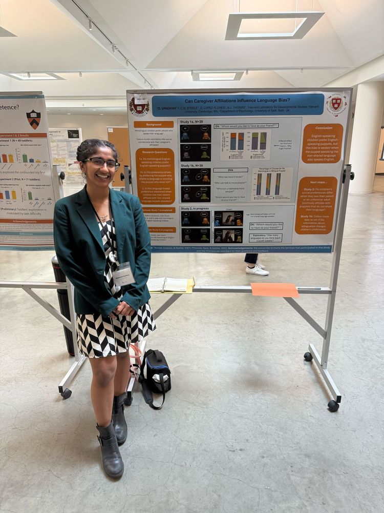 Woman standing next to a scientific poster