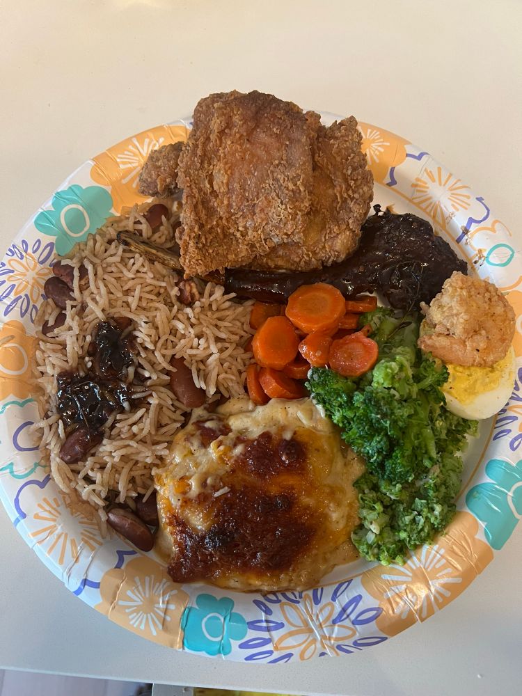 Jamaican rice and peas, scalloped potatoes, broccoli, glazed carrots, jerk lamb chop; fried chicken thigh and a deviled egg with fried shrimp 