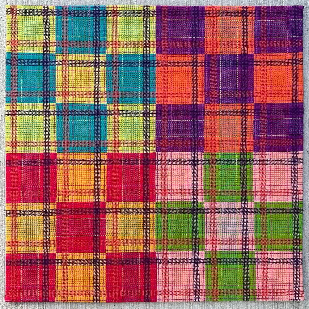 Description: How do thread color and weight combine with quilting density to alter the overall impression of simple patchwork? 

This quilt consists of four nine-patch quilt blocks featuring bright colors. The intense color continues with the 50, 40, 28, and 12-weight quilting threads. While the thread color repeats throughout the quilt, the appearance alters depending on the fabric color behind it. Decorative machine stitching creates additional density within the plaid effect of the quilting. 